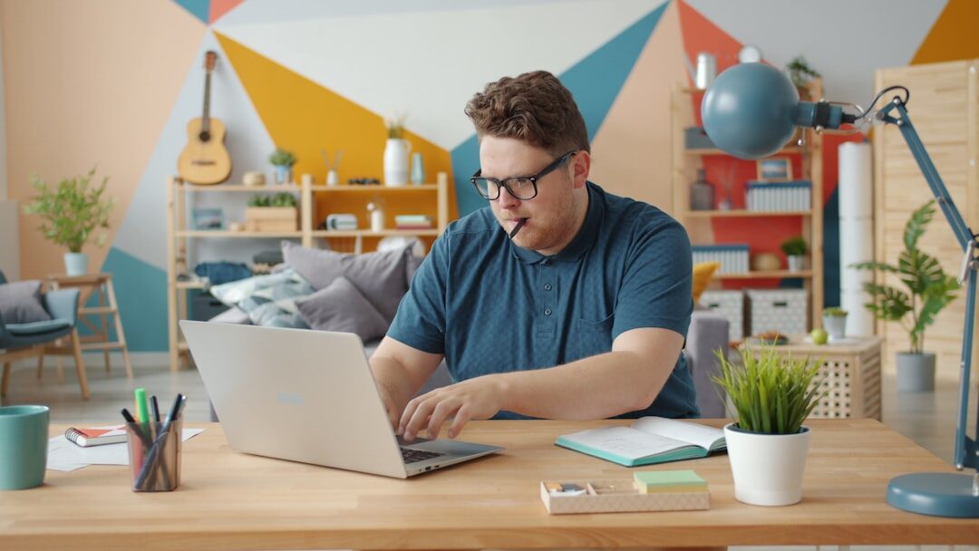 person writing on laptop